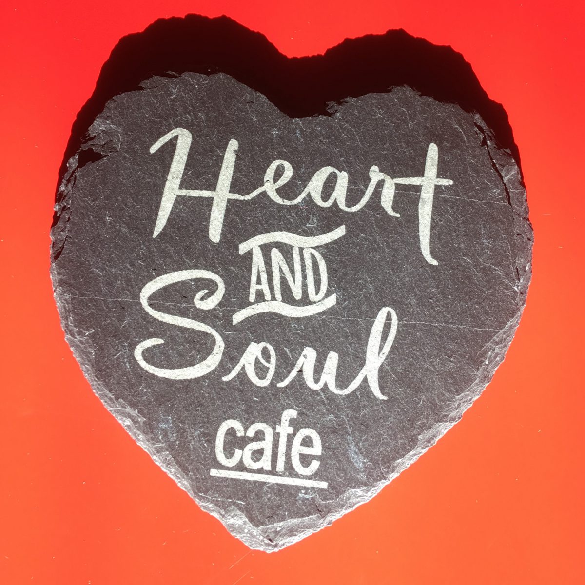 Heart shaped stone with 'Heart and Soul Cafe' written on it